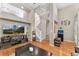 The bright living room showcases hardwood floors, tall ceilings, and an open floor plan with a cozy, inviting atmosphere at 9503 Longs Peak Dr, Commerce City, CO 80640