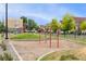 Community playground with swings and climbing area, surrounded by green space and residential buildings at 9503 Longs Peak Dr, Commerce City, CO 80640