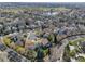 Panoramic aerial view of a neighborhood with mature trees, a pond, and well-maintained homes on a sunny day at 2533 W 110Th Ave, Westminster, CO 80234