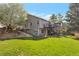 Expansive backyard with lush green lawn, a fire pit, and a multi-level deck at 2533 W 110Th Ave, Westminster, CO 80234