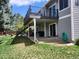 Grassy backyard with a covered patio, outdoor seating, and lush landscaping at 2533 W 110Th Ave, Westminster, CO 80234