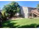 Spacious backyard featuring a large tree providing shade, a fire pit, and a multi-level deck at 2533 W 110Th Ave, Westminster, CO 80234