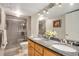 Elegant bathroom featuring a double vanity, granite countertops, and glass shower at 2533 W 110Th Ave, Westminster, CO 80234