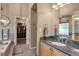 Bathroom showcasing a granite vanity, a walk-in closet, and a tiled tub at 2533 W 110Th Ave, Westminster, CO 80234
