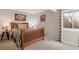 Cozy bedroom with a wooden bed frame, neutral carpet, and a sunny window at 2533 W 110Th Ave, Westminster, CO 80234