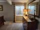 Neutral-toned bedroom with wood dresser, woven shades, and carpeted floors at 2533 W 110Th Ave, Westminster, CO 80234