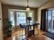 Bright dining area featuring a bay window, hardwood floors, modern lighting, and sliding glass doors at 2533 W 110Th Ave, Westminster, CO 80234
