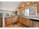 Spacious kitchen featuring natural wooden cabinets, tiled backsplash, and modern stainless steel appliances for easy cooking at 2533 W 110Th Ave, Westminster, CO 80234