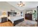 Spacious main bedroom with hardwood floors, ceiling fan, en-suite bath, and a large dresser at 2533 W 110Th Ave, Westminster, CO 80234