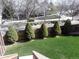 Well-maintained yard featuring lush green grass, trimmed evergreens, and a neat wood fence at 2533 W 110Th Ave, Westminster, CO 80234