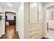 Hallway view featuring built in cabinet storage and arched doorway at 2233 Kearney St # 19, Denver, CO 80207