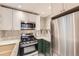 Bright kitchen featuring stainless steel appliances, white cabinets, quartz countertops, and modern backsplash at 2233 Kearney St # 19, Denver, CO 80207