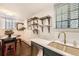 A bright kitchen with quartz countertops, floating shelves, stainless steel appliances and a dining area at 2233 Kearney St # 19, Denver, CO 80207