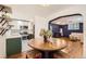Open-concept living space with a dining table and updated kitchen featuring stainless steel appliances and white cabinets at 2233 Kearney St # 19, Denver, CO 80207