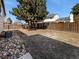 Spacious backyard with a wooden fence surrounding the space and a large tree providing shade for relaxation at 18945 E 45Th Ave, Denver, CO 80249