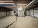 Unfinished basement with concrete floors, exposed utilities, and staircase leading upstairs at 18945 E 45Th Ave, Denver, CO 80249