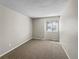 Cozy bedroom with neutral carpet and a window offering natural light at 18945 E 45Th Ave, Denver, CO 80249