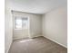 Neutral bedroom with a plush carpet, a window and an electrical outlet at 18945 E 45Th Ave, Denver, CO 80249