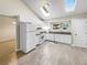 Bright kitchen with white cabinets, modern appliances, and a skylight allowing natural light to illuminate the space at 18945 E 45Th Ave, Denver, CO 80249