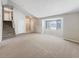 Bright living room with vaulted ceilings, neutral carpet, a large window and staircase at 18945 E 45Th Ave, Denver, CO 80249
