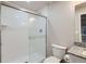 This bathroom features a white tiled shower with glass door and granite countertop at 18809 E 66Th Ave, Denver, CO 80249