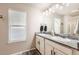 Bright bathroom with double sinks, granite countertops, and modern fixtures at 18809 E 66Th Ave, Denver, CO 80249