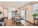 Cozy dining area with hardwood floors, a round table, and sliding glass doors for natural light at 18809 E 66Th Ave, Denver, CO 80249
