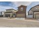 Exterior of a two-story home featuring a brown facade, two car garage, and well-maintained landscaping at 18809 E 66Th Ave, Denver, CO 80249