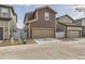 Two-story home featuring a brown facade, two car garage, and low maintenance landscaping at 18809 E 66Th Ave, Denver, CO 80249