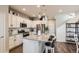 Modern kitchen with white cabinetry, granite countertops, stainless steel appliances, and a center island at 18809 E 66Th Ave, Denver, CO 80249