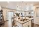 Open-concept kitchen overlooking the living area, boasting a large island with seating and modern fixtures at 18809 E 66Th Ave, Denver, CO 80249