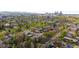 A stunning aerial perspective of residential homes, highlighting the beautiful city skyline and lush green trees at 1090 E 3Rd Ave, Denver, CO 80218