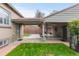 Back patio featuring brick flooring, ceiling fans and posts along with backyard and lush lawn view at 1090 E 3Rd Ave, Denver, CO 80218