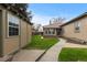 Backyard with lush lawn, patio and sidewalks connecting the house and outbuilding on the property at 1090 E 3Rd Ave, Denver, CO 80218