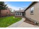 Well-maintained backyard with lush lawn, flower beds, sidewalk and access to an additional structure at 1090 E 3Rd Ave, Denver, CO 80218