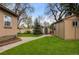 A spacious backyard featuring lush green grass, a shed, and privacy fencing at 1090 E 3Rd Ave, Denver, CO 80218