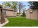 A spacious backyard with lush green grass and detached outbuilding at 1090 E 3Rd Ave, Denver, CO 80218
