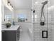 Modern bathroom featuring white subway tiles, hexagon tile flooring, and sleek fixtures at 1090 E 3Rd Ave, Denver, CO 80218