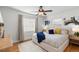 Bright bedroom with a ceiling fan, plush bed, and natural light from the window at 1090 E 3Rd Ave, Denver, CO 80218