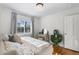 Charming bedroom with hardwood floors, a sunny window, and playful decor at 1090 E 3Rd Ave, Denver, CO 80218