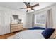 Bright bedroom featuring a ceiling fan, plush bed, and natural light from the window at 1090 E 3Rd Ave, Denver, CO 80218
