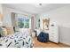 Bright bedroom with a plush bed, vanity, and natural light from the window at 1090 E 3Rd Ave, Denver, CO 80218