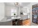 Sunlit breakfast nook boasts a cozy built-in bench, marble table, and chic storage for a modern touch at 1090 E 3Rd Ave, Denver, CO 80218