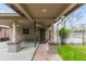 Inviting carport entry with brick pillars, ceiling fans, and a charming walkway to the front door at 1090 E 3Rd Ave, Denver, CO 80218