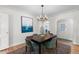 Bright dining area featuring a chandelier, statement art, and seamless flow into adjacent rooms at 1090 E 3Rd Ave, Denver, CO 80218