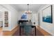 Spacious dining area featuring a modern chandelier, statement art, and seamless flow into the breakfast nook at 1090 E 3Rd Ave, Denver, CO 80218