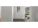 Cozy entryway with tile flooring, white door, and lush greenery at 1090 E 3Rd Ave, Denver, CO 80218