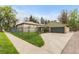 Charming home exterior featuring a well-manicured lawn, a secure fence, and a detached garage at 1090 E 3Rd Ave, Denver, CO 80218