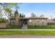 Charming brick home featuring a classic design, a well-manicured lawn, and secure fencing at 1090 E 3Rd Ave, Denver, CO 80218