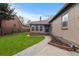 Home's rear exterior with lush landscaping, walkway, and brick accents at 1090 E 3Rd Ave, Denver, CO 80218